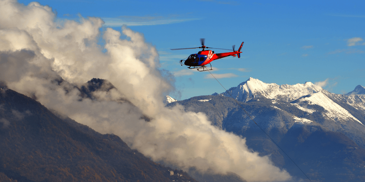 helicopter-flying-through-the-clouds-over-the-snowy mountains